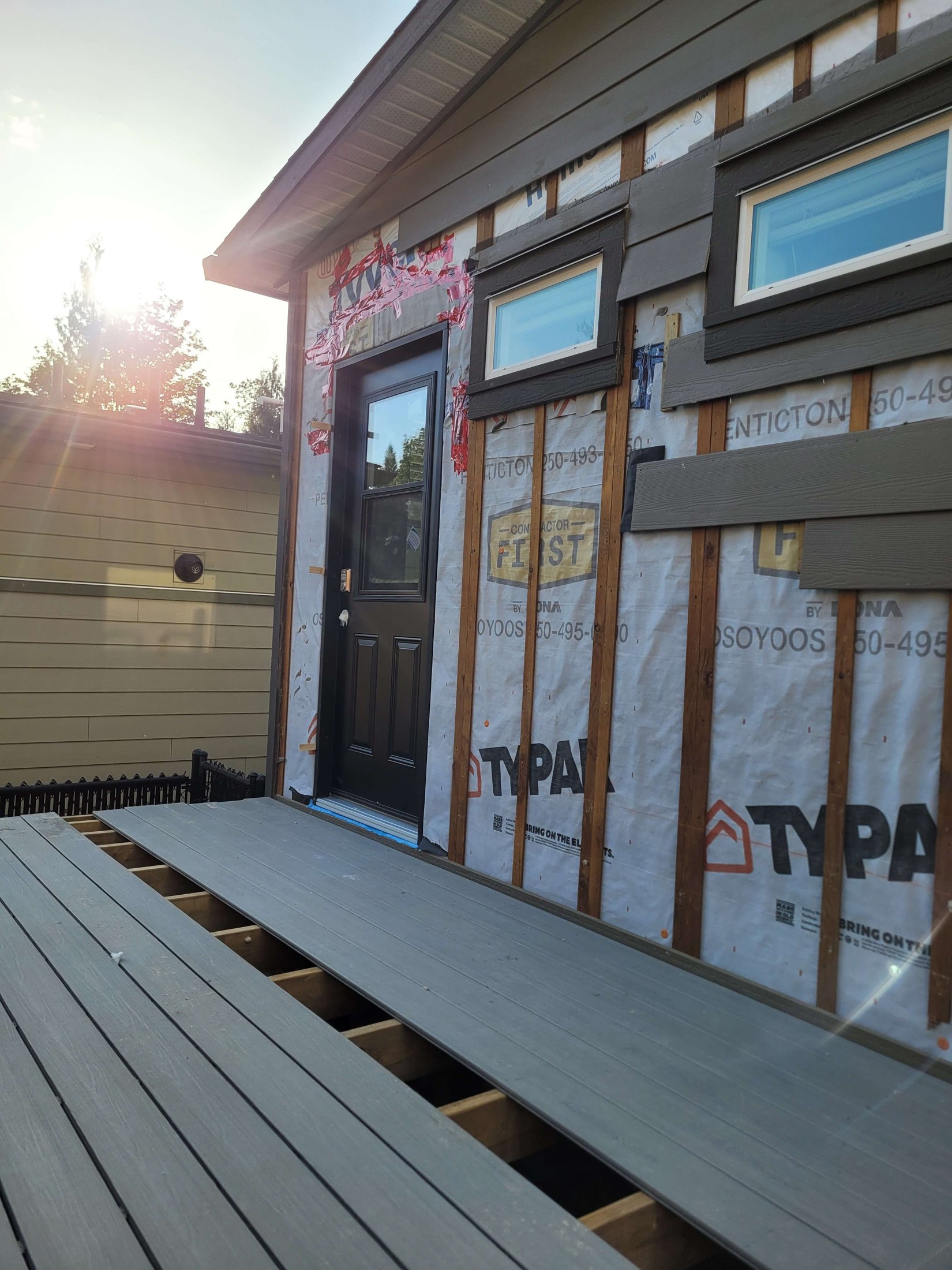 New door opening and composite decking installation in progress