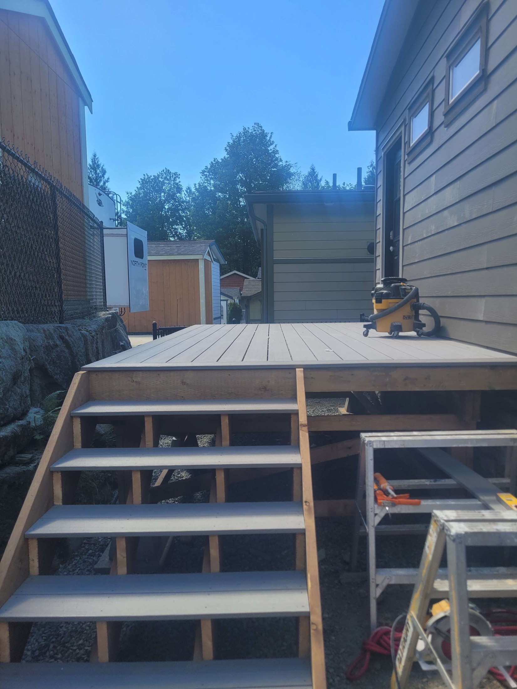 Deck stairs being built beneath the composite landing