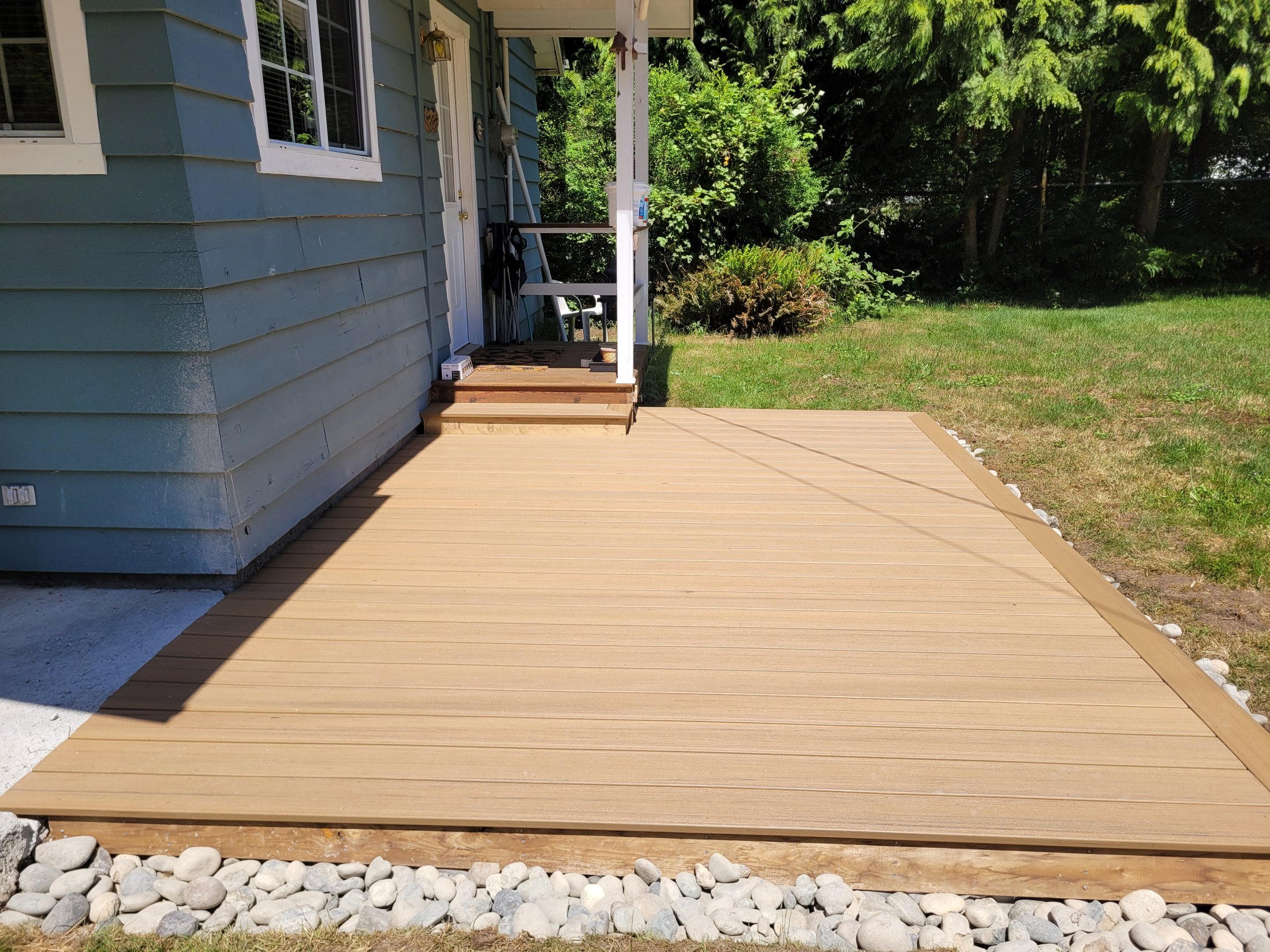 Finished composite deck blended level with the cabin front porch