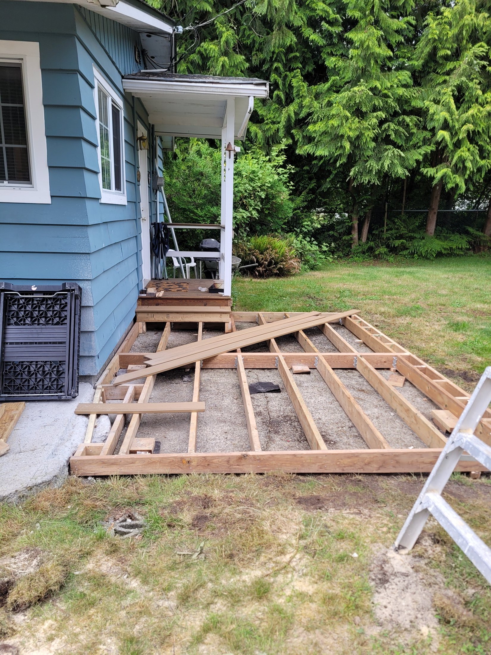 Pressure-treated 2x6 deck framing constructed over the concrete slab