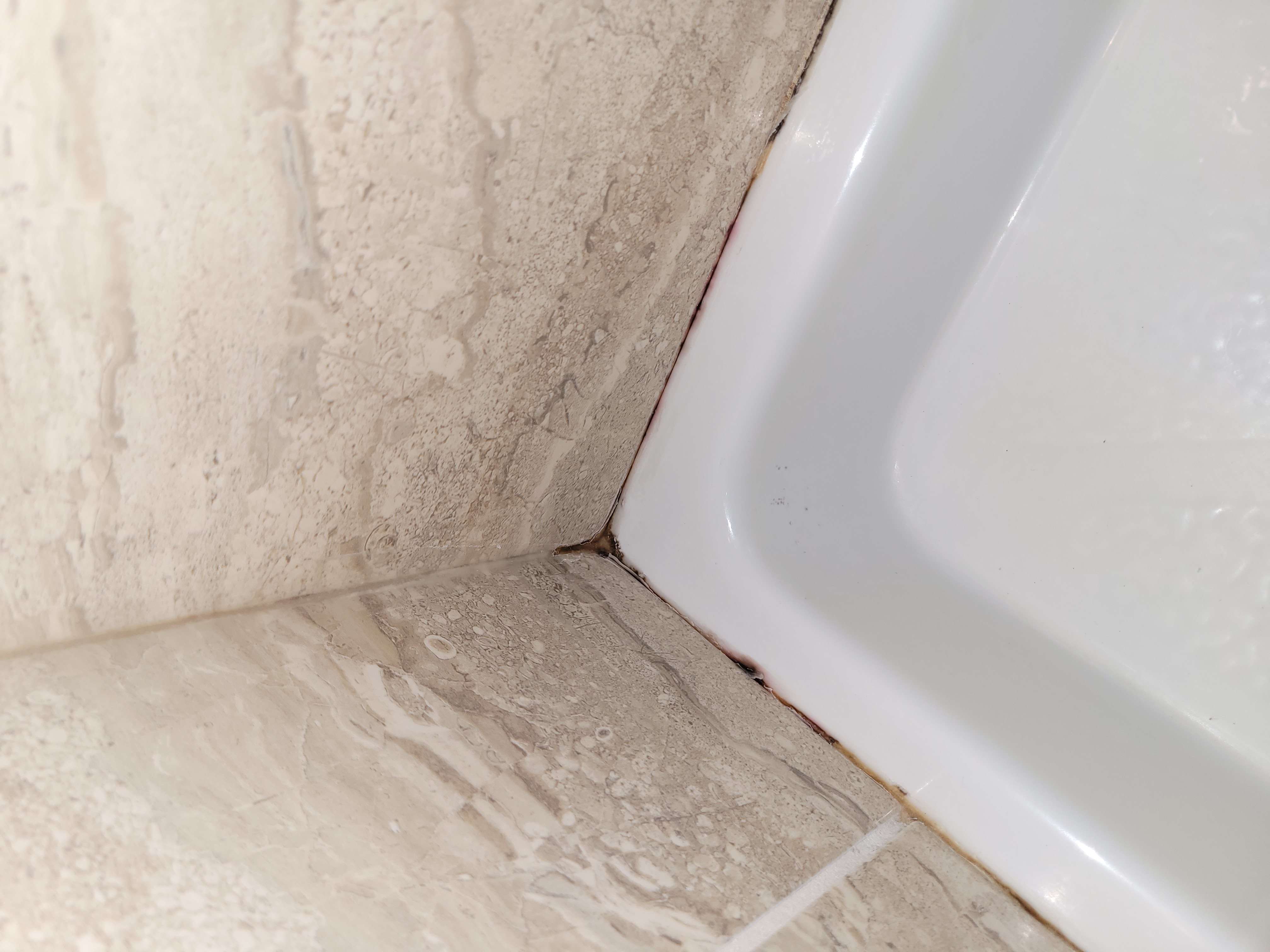 Before - Silicone reseal (mouldy caulk)