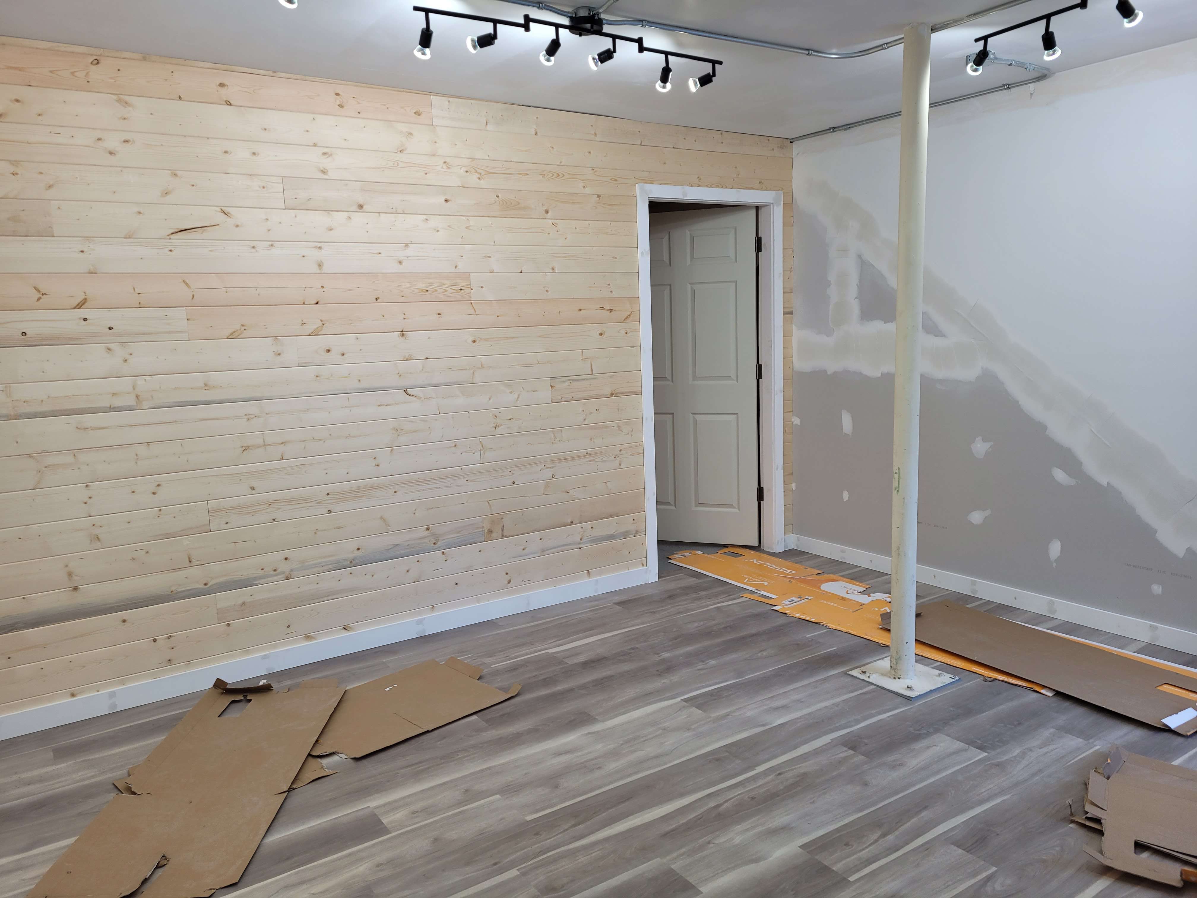 T&G Pine wall finish and new laminate floor in small shop. 
